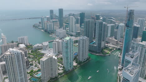 Aerial-descending-shot-of-group-of-luxury-apartment-or-office-towers-on-waterfront.-Modern-city-borough.-Miami,-USA