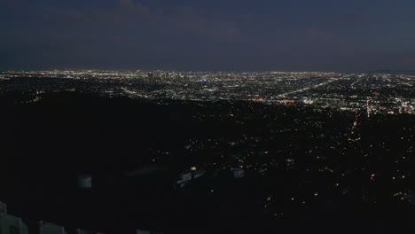 Antenne:-Spektakulärer-Dolly-über-Hollywood-schild-Bei-Nacht-Mit-Lichtern-Der-Stadt-Los-Angeles