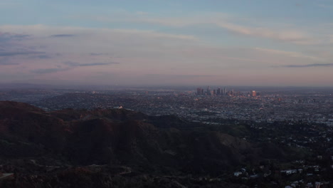 AERIAL:-Breathtaking-View-over-Hollywood-Hills-with-Los-Angeles-Cityscape-in-Beautiful-Sunset-Light