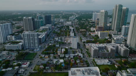 Aerial-view-of-buildings-in-urban-borough-after-sunset.-Heavy-traffic-in-multilane-streets.-Miami,-USA