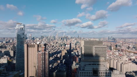Forwards-fly-above-long-straight-wide-Broadway-street-leading-to-downtown-with-modern-office-skyscrapers.-Panoramic-footage-of-large-city.-Manhattan,-New-York-City,-USA