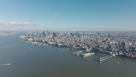 Amazing-aerial-panoramic-footage-of-Hudson-river-waterfront-and-tall-business-skyscrapers.-Downtown-high-rise-buildings.-Manhattan,-New-York-City,-USA