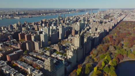 Sunny-day-in-residential-borough.-Aerial-view-of-buildings-near-autumn-Central-Park.-Manhattan,-New-York-City,-USA