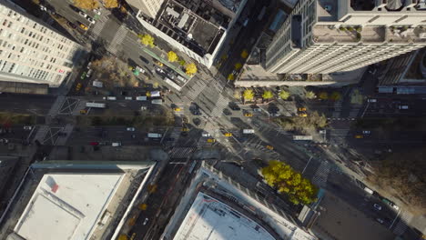 Aerial-birds-eye-overhead-top-down-view-of-cars-passing-through-intersection.-Crossing-of-multiple-streets-in-city.--Manhattan,-New-York-City,-USA