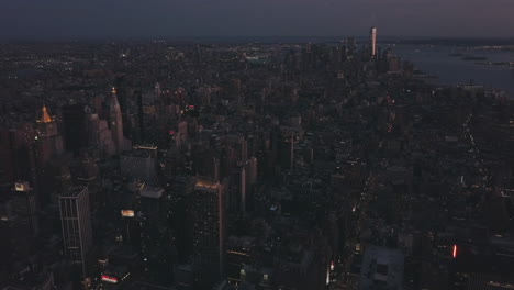 AERIAL:-Manhattan-Drone-Flight-at-Night-with-Glowing-City-Light-in-New-York-City