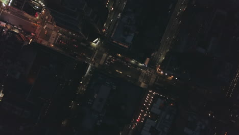 AERIAL:-Overhead-Manhattan-Drone-Flight-at-Night-with-Glowing-City-Light-in-New-York-City