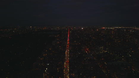 Aerial-panoramic-view-of-night-City.-High-angle-view-of-transport-thoroughfare-leading-through-city.-Traffic-on-avenue.-Manhattan,-New-York-City,-USA