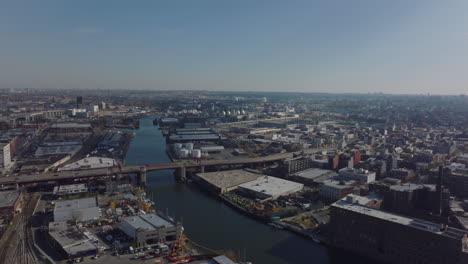 Aerial-panoramic-view-of-town-development-along-Newtown-Creek.-Industrial-and-logistic-sites-on-waterfront.-New-York-City,-USA
