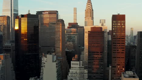 Ascending-fly-in-city.-Tall-skyscrapers-in-evening-sun.-Chrysler-and-MetLife-buildings.-Manhattan,-New-York-City,-USA