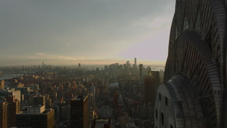 Fly-around-top-of-Chrysler-Building.-Revealing-aerial-view-of-cityscape-in-sunset-time.-Manhattan,-New-York-City,-USA