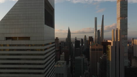 Slider-of-modern-buildings-in-midtown.-Aerial-view-of-city-at-sunset-time.-Manhattan,-New-York-City,-USA