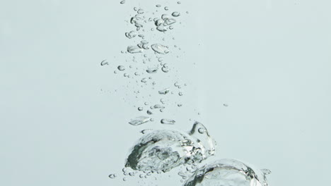 Whole-cucumber-falling-water-in-light-background-closeup.-Fresh-green-vegetable