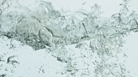 Closeup-avocados-falling-water-in-light-background.-Healthy-natural-nutrition.