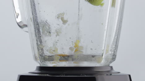 Chopping-fresh-fruits-blender-for-making-vegetarian-food-closeup.-Tasty-cocktail