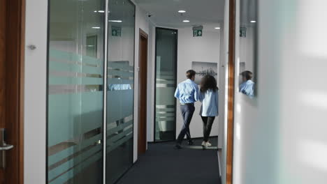 Man-woman-using-tablet-computer-in-office-center.-Colleagues-discussing-together