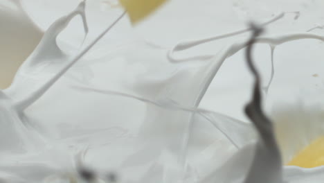 Pineapple-falling-fresh-milk-making-splashes-in-super-slow-motion-close-up.