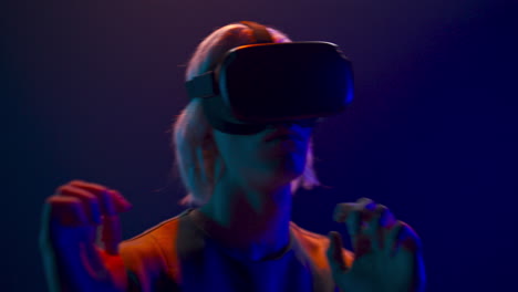 Involved-guy-visit-virtual-party-closeup.-Man-immersed-in-abstract-neon-vr-world