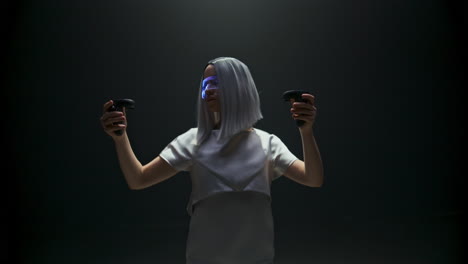 Girl-playing-futuristic-vr-game-in-studio-light.-Focused-beautiful-gamer-holding