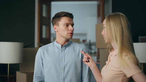 Conflicted-wife-swearing-husband-at-home-waving-finger-close-up.-Family-arguing.