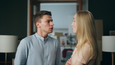 Angry-couple-discussing-disagreement-in-unhappy-relationship-at-home-close-up.