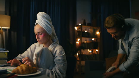 Focused-lady-texting-keyboard-home-closeup.-Carefree-man-distracting-girlfriend