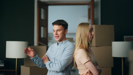 Man-expressing-disagreement-woman-in-new-house-close-up.-Couple-quarrelling.