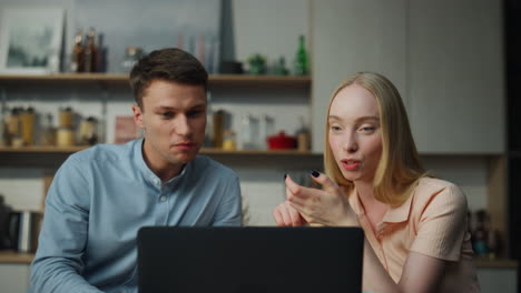 Couple-enjoying-virtual-meeting-by-laptop-at-kitchen-closeup.-Pair-communicating