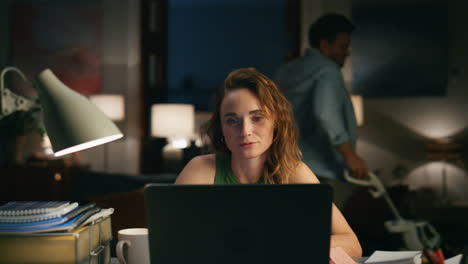 Successful-woman-calling-remotely-at-flat-closeup.-Lady-talking-laptop-at-night