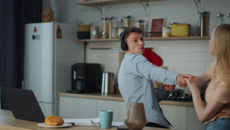 Cheerful-couple-dancing-kitchen-having-fun-together.-Happy-marriage-concept.