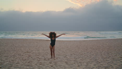 Woman-traveler-running-beach-enjoying-summer-vacation.-Girl-posing-near-ocean