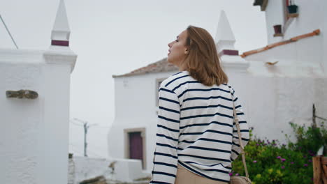 Girl-walking-old-town-on-summer-vacation.-Mediterranean-whitewashed-architecture