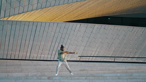 Creative-dancer-performing-contemporary-bunch-on-stairs-vertical.-Guy-moving