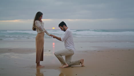 Amorous-lovers-engaging-sunset-seashore.-Handsome-man-making-surprise-proposal