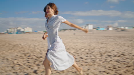 Friends-running-sandy-beach-holding-hands-in-morning.-Lgbt-couple-enjoy-summer