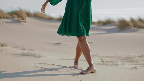 Woman-legs-dancing-sand-desert-summer-day-close-up.-Unknown-girl-moving-smoothly