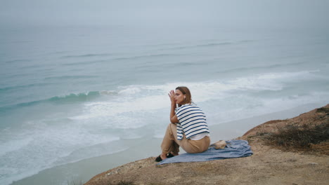 Serene-woman-listening-music-relaxing-at-ocean-vertical.-Thinking-girl-resting