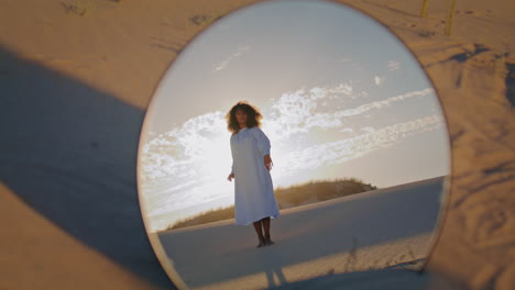 Woman-dancing-reflecting-mirror-at-sand-desert.-African-american-girl-performing