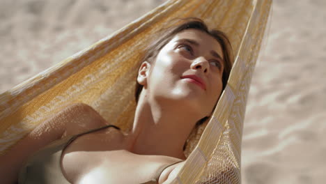 Closeup-girl-relaxing-hummock-in-summer-sunlight.-Carefree-woman-resting-beach