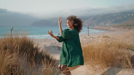 Artistic-woman-dancer-performing-sensual-dance-on-sand-seashore.-Girl-dancing.