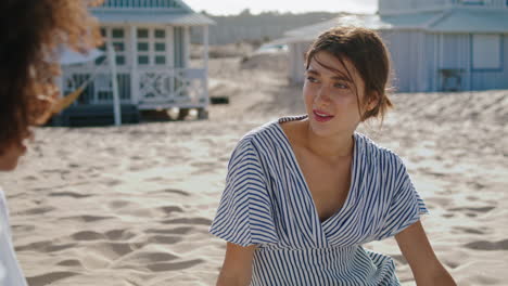 Friends-spending-beach-time-discussing-book.-Closeup-smiling-attractive-girl