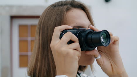 Closeup-photographer-looking-camera-taking-pictures.-Beautiful-tourist-resting