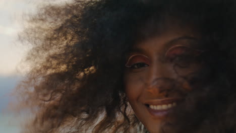 Curly-girl-smiling-camera-at-gloomy-nature-close-up.-Portrait-african-woman.