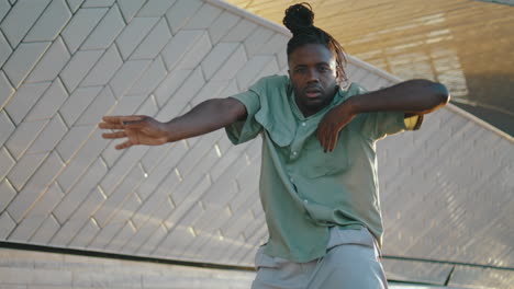 Dreadlocks-guy-moving-arms-urban-street-closeup.-Black-hair-man-dancing-hand