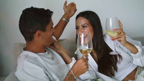 Laughing-woman-treating-husband-at-sofa-closeup.-Happy-sweethearts-having-fun