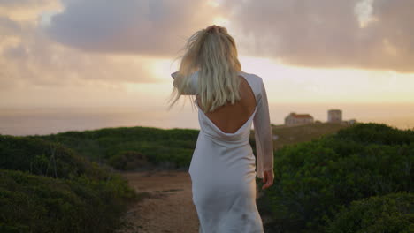 Beaming-lady-walk-chateau-hilltop-vertical-closeup.-Girl-stepping-sunset-valley