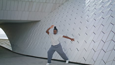Graceful-choreographer-training-at-urban-place-vertical.-Creative-man-dancing