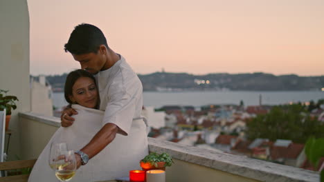 Sensual-girl-embracing-man-terrace-vertical-closeup.-Affectionate-couple-hugging