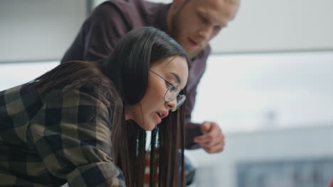 Manos-De-Arquitectos-De-Primer-Plano-Dibujando-En-La-Oficina-Panorámica.-Hombre-Serio-Ayudando-A-Mujer