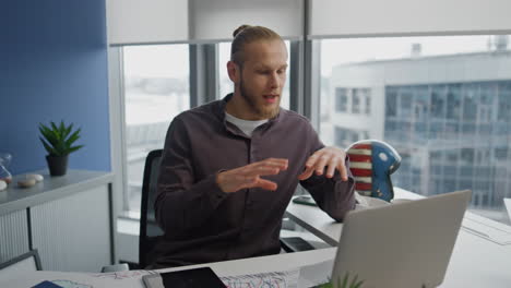 Positive-programmer-videocalling-computer-at-home-closeup.-Man-talking-online