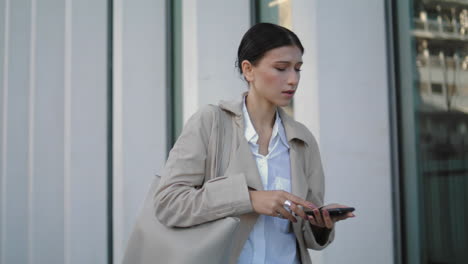 Girl-received-message-going-work-closeup.-Woman-looking-telephone-vertically